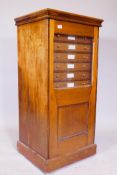 A pine naturalist collector's cabinet with glazed and panelled door opening to reveal thirteen slide