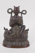 A bronze Buddha seated upon a stylised lotus throne, 16cm high