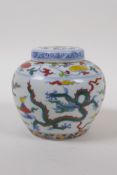 A Chinese Wucai porcelain ginger jar and cover decorated with dragons in flight, character mark to