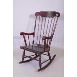 A stained beech wood rocking chair