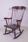 A stained beech wood rocking chair