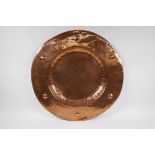 An antique copper Newlyn style charger, 57cm diameter