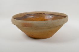 A slip glazed terracotta bowl, 35cm diameter