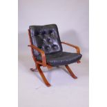 A mid century bentwood and button leather easy chair