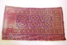 A red ground Bokhara rug, faded, 153cm x 85cm