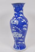 A Chinese KangXi pottery blue and white vase decorated with prunus blossom on a cracked ice