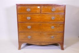 A George III mahogany chest of two over three drawers, with brass oval plate handles and