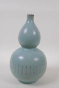 A Chinese Ru ware style porcelain double gourd vase with an engraved character inscription to