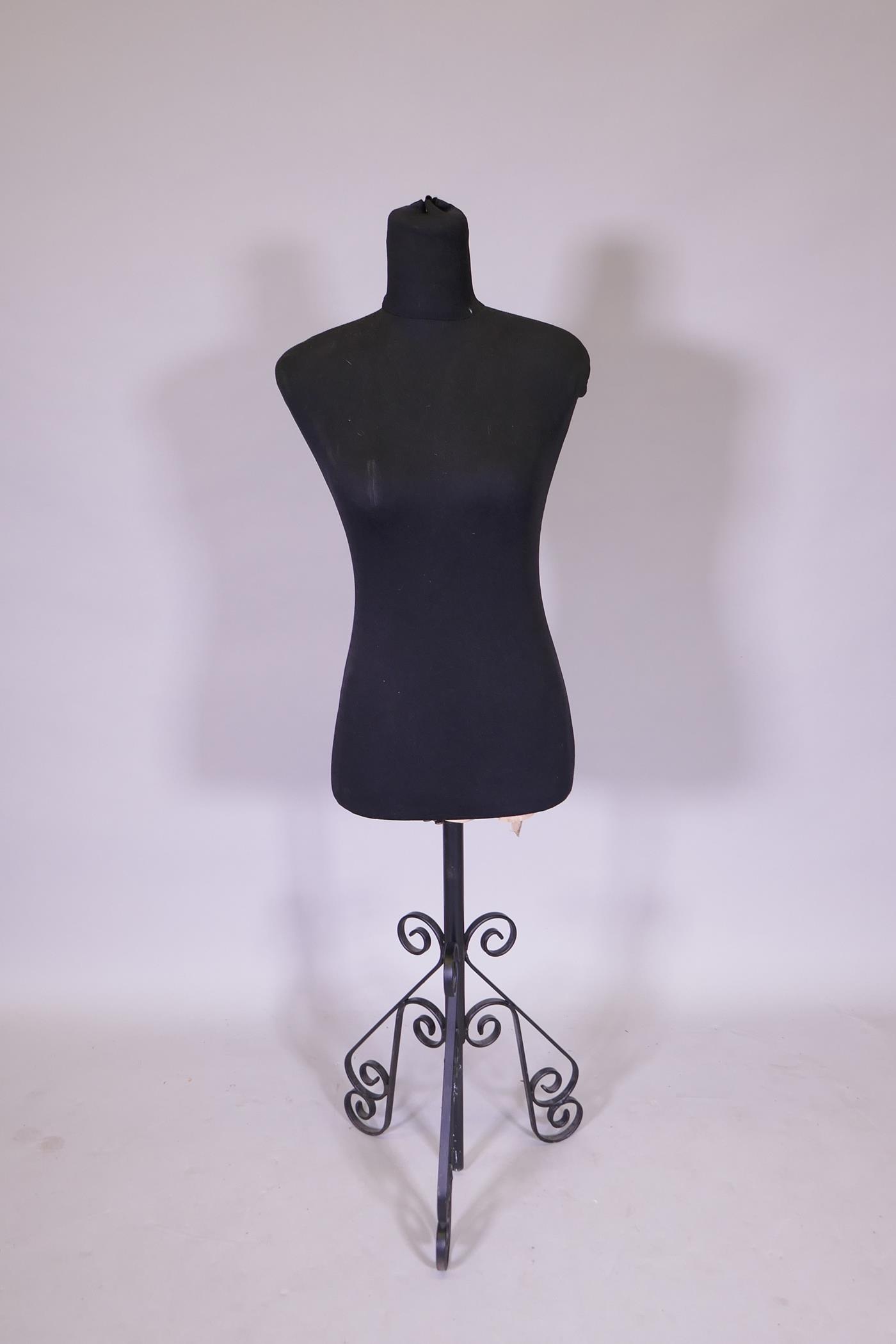 A tailor's dummy on an adjustable wrought metal base, 128cm high