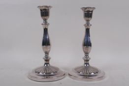 A pair of silver plated candlesticks, 25cm high