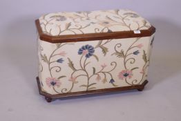 A sarcophagus shaped ottoman with mahogany frame and floral upholstery, 50cm high, 70cm wide