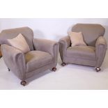 A pair of Art Deco armchairs, well upholstered in a neutral fabric
