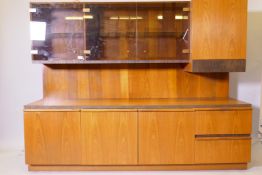 A 1970s McIntosh teak sideboard with a glazed and illuminated upper section, 180cm x 50cm, 140cm