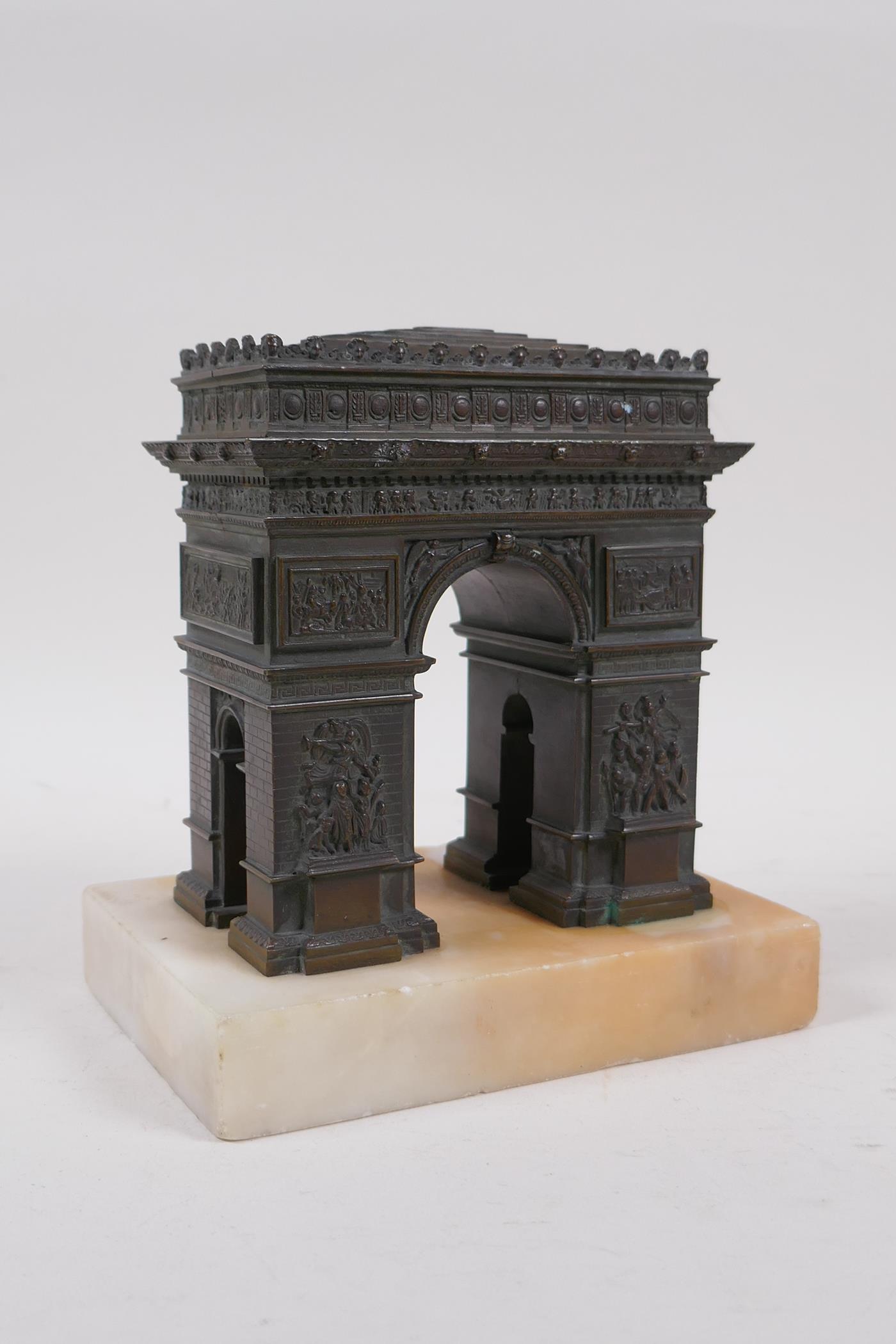 A Grand Tour style bronze Arc de Triomphe, on a marble base, 14cm x 10cm, 16cm high