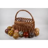 A collection of vintage decorative specimen balls, containing seed pods, nuts, star fish etc, in a