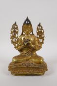 A Tibetan gilt bronze figure of Buddha seated on a lotus throne, 21cm high, impressed double vajra