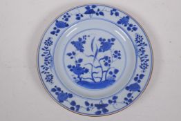 An antique Chinese blue and white porcelain plate painted with flowers, 22cm diameter