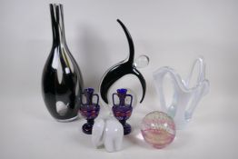 A collection of decorative glassware including a stylised dancing figure, a large bottle vase,