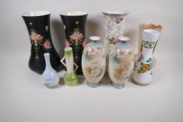 A pair of tall Crown Devon pottery vases painted with flowers on a black ground, 30cm high, and a