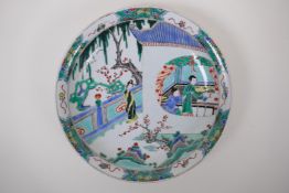 A famille vert porcelain charger decoration with figures in a temple compound, Chinese KangXi 6