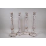 Two pairs of painted and distressed pricket candlesticks, 46cm high