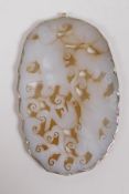 A Chinese carved and pierced white jade pendant decorated with boys, in a white metal mount, 6 x