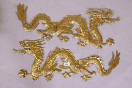 A pair of brass mounts in the form of Chinese dragons, 70cm long