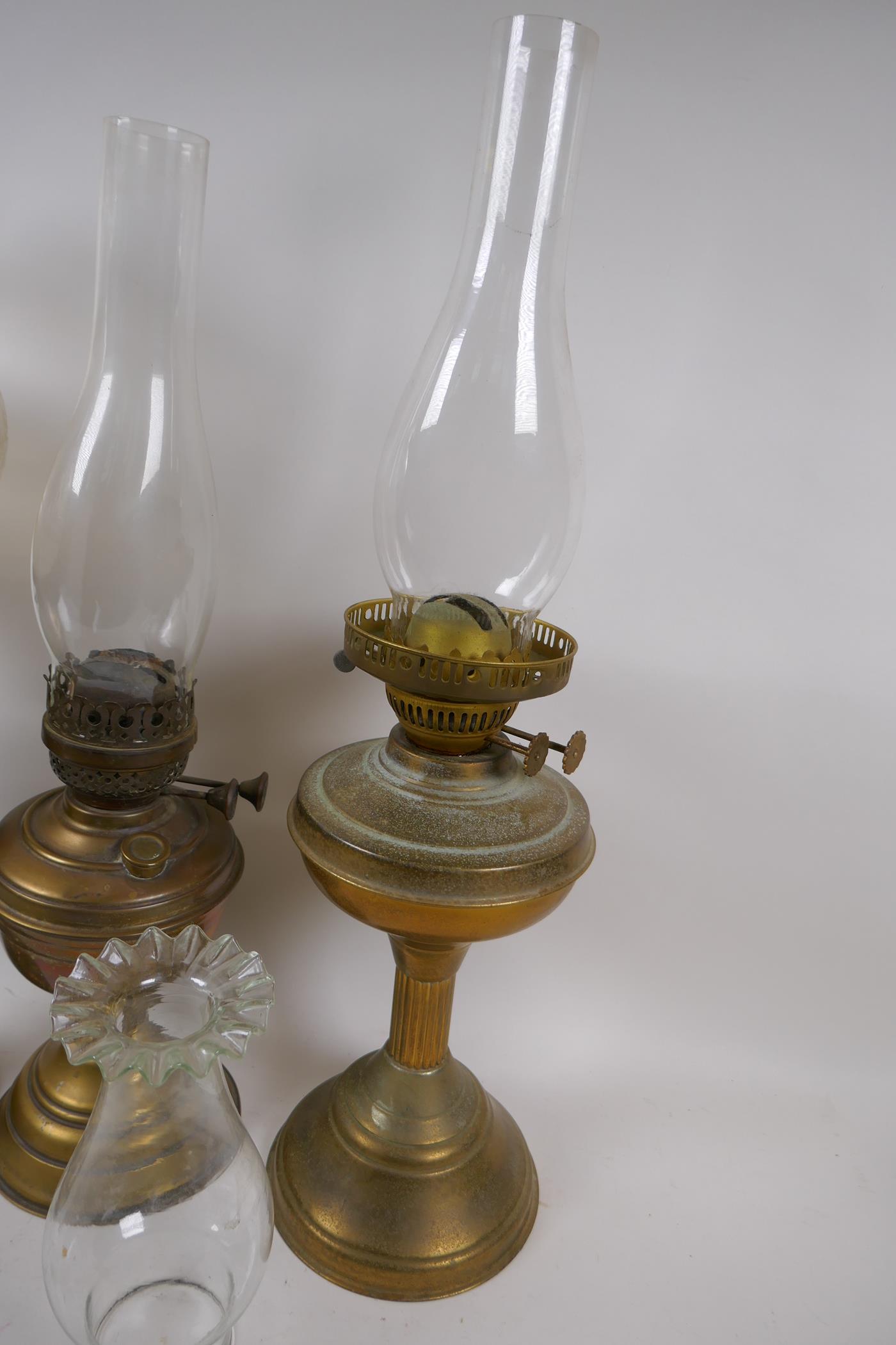 A near pair of brass column oil lamps and another similar, with one engraved shade and various - Image 2 of 4