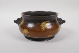 A Chinese bronze censer with two mask handles and gilt patina, 6 character to base, 16cm diameter