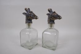 A pair of contemporary glass decanters with gilt giraffe stoppers, 24cm high