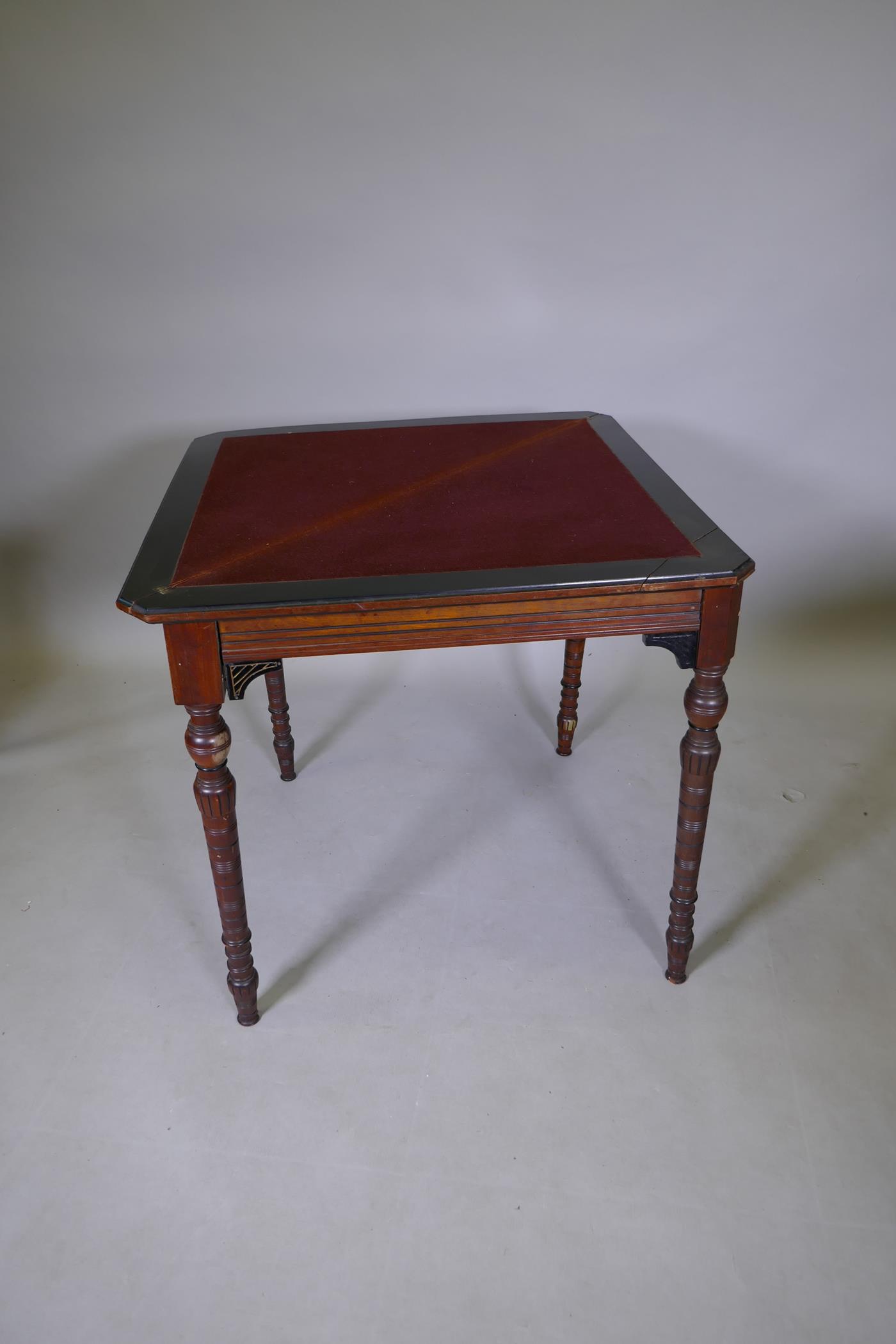 An Arts & Crafts satinwood and coromandel games table with fold over top and turned supports, 75 x - Image 4 of 7