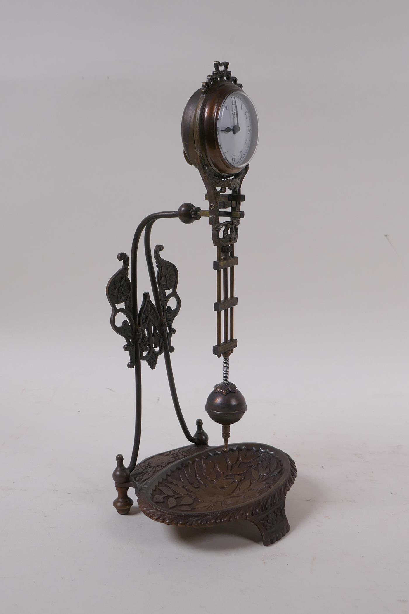 A bronzed metal mystery clock with a trinket dish base, 28cm high - Image 2 of 2