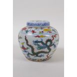 A Chinese Wucai porcelain ginger jar and cover decorated with dragons in flight, character mark to