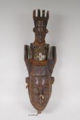 An antique African carved wood mask with a fabric bound figural surmount, possibly West African,ÿ 20