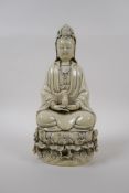 A blanc de chine porcelain figure of Quan Yin seated on a lotus flower, impressed Chinese seal marks