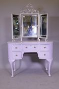 A painted kidney shaped dressing table with five drawers, raised on cabriole supports, 105cm x
