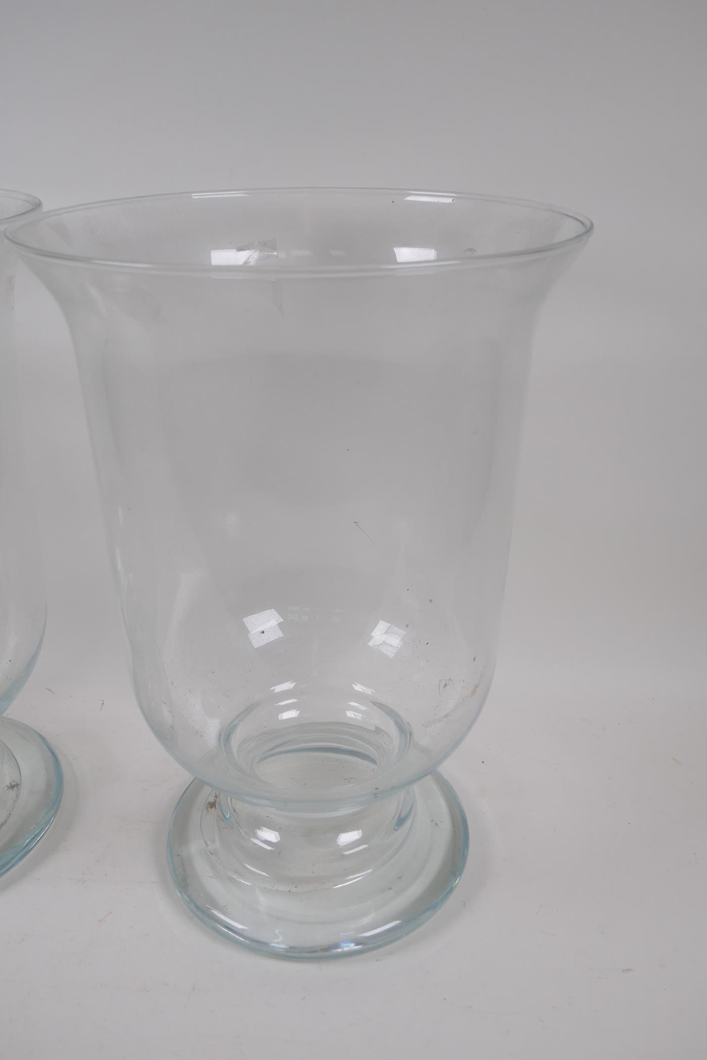 A pair of blown glass hurricane vases on pedestal feet, 39cm high, 27cm diameter - Image 2 of 4
