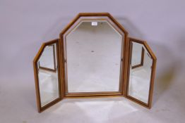 A walnut and parcel gilt triptych dressing table mirror, with bevelled glass and swinging central