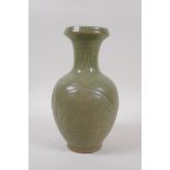 A Chinese olive green glazed porcelain vase with underglaze scrolling floral decoration, 23cm high