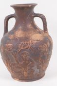 A Greco/Roman style red earthenware two handled vase embossed with images of gods, the base with a