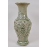 An oriental celadon glazed porcelain vase, embossed with dragons (drilled), 30cm