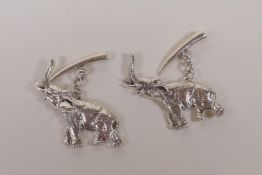 A pair of sterling silver cufflinks in the form of elephants