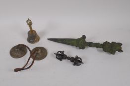 A collection of Sino Tibetan ceremonial items to include an iron phurba, a bronze vajra, a set of