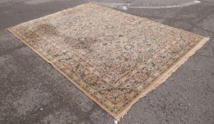 A large Belgian beige ground wool oriental carpet with an all over design depicting hunting