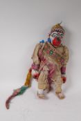 An Indonesian carved and painted wood and fabric Hanuman puppet, 43cm high