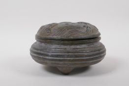 A Chinese bronze censer and cover on tripod supports, with ribbed body and wave decoration to the