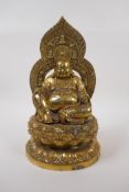 A Chinese brass figure of Buddha seated on a lotus flower, impressed 4 character mark to base,
