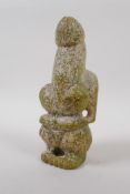 An oriental carved green hardstone fertility figure, 21cm high