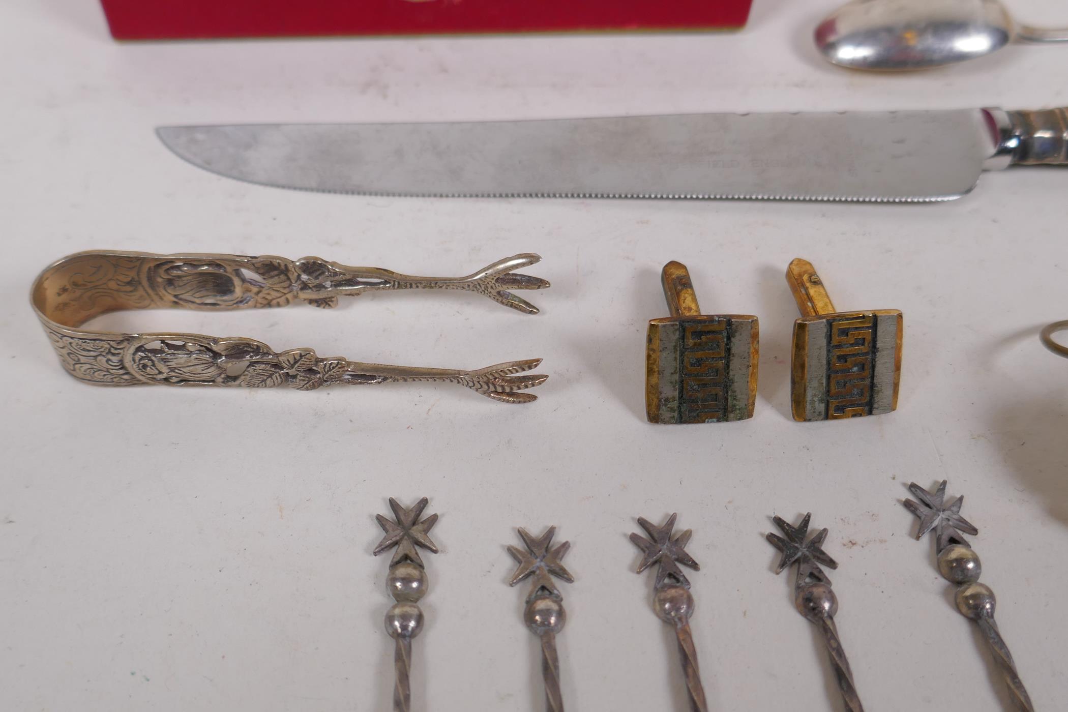 A collection of silver, silver plate and white metal items to include tea spoons, coin spoons, - Image 7 of 9