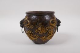 A Chinese bronze censer with two lion mask handles, and raised gilt dragon decoration, 4 character